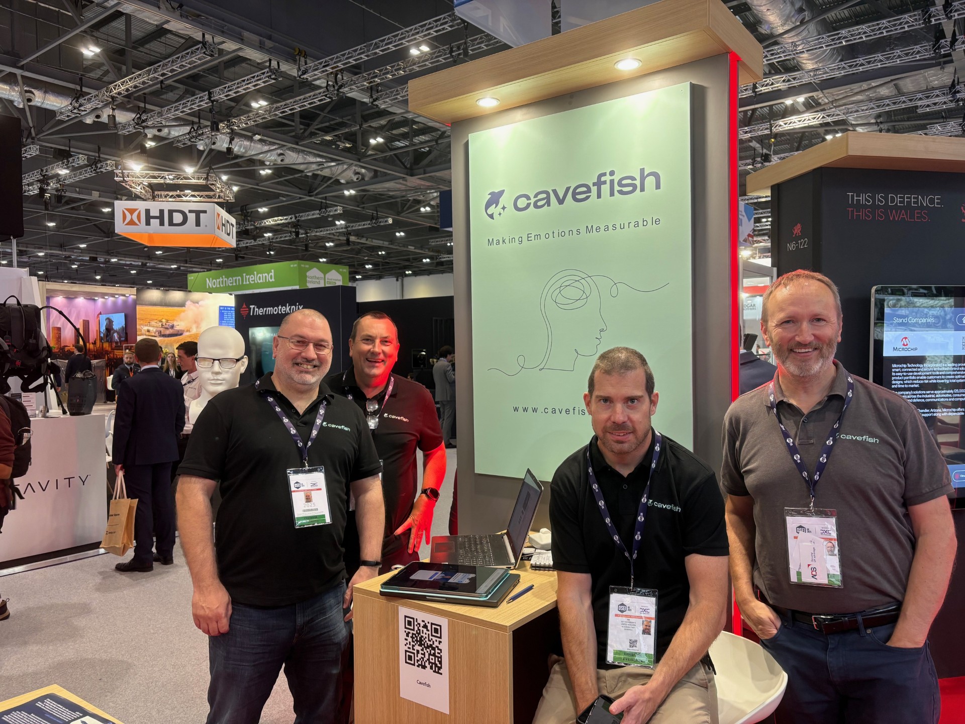 Cavefish team at DSEI London — the Defence and Security Equipment International exhibition, ExCeL London. The Cavefish stand with the tagline Making Emotions Measurable alongside the Welsh Government's THIS IS DEFENCE. THIS IS WALES. pavilion.